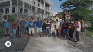 JMG Construction team with community members in front of an ongoing construction project in Cagayan de Oro.