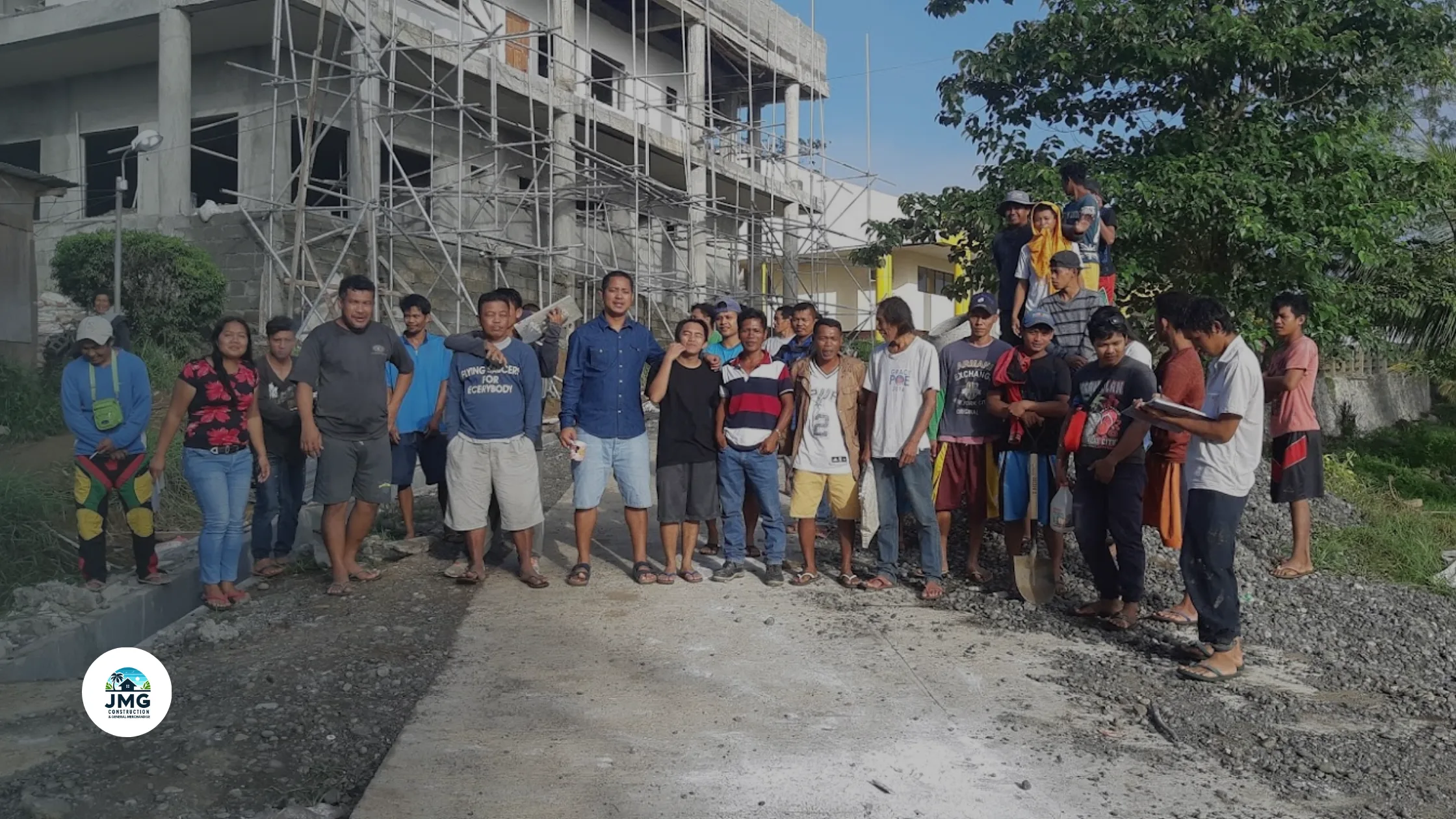 JMG Construction team with community members in front of an ongoing construction project in Cagayan de Oro.